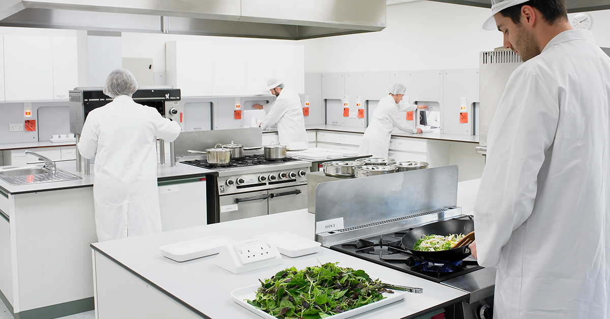 Campden BRI staff preparing food in kitchen for tasting